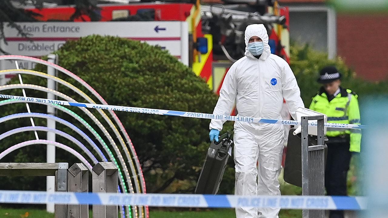 A specialist in a white suit walks away after inspecting the scene of a car blast outside the Women's Hospital in Liverpool. Picture: AFP