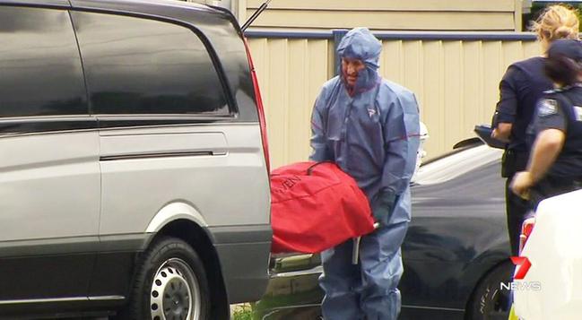 Police and forensic officers inspect a Booval property where a man was fatally shot. The undertaker removes the body from the scene. Photo: Contributed / Seven News. Picture: Contributed