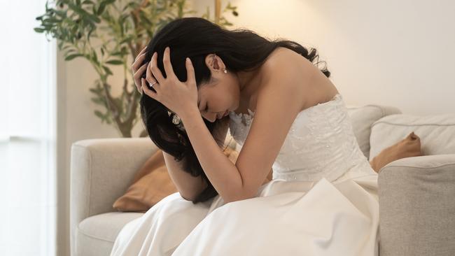 Sad and worried bride crying and arguing with groom in wedding day