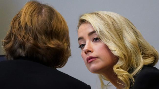 Actor Amber Heard talks with her lawyer Elaine Bredehoft at the Fairfax County Circuit Courthouse in Fairfax, Virginia on May 18, 2022. Picture: AFP