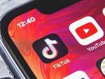 TikTok and YouTube apps on screen iphone xr, close up