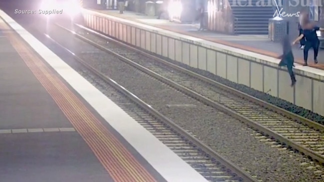 Terrifying moment man falls from platform into path of oncoming train