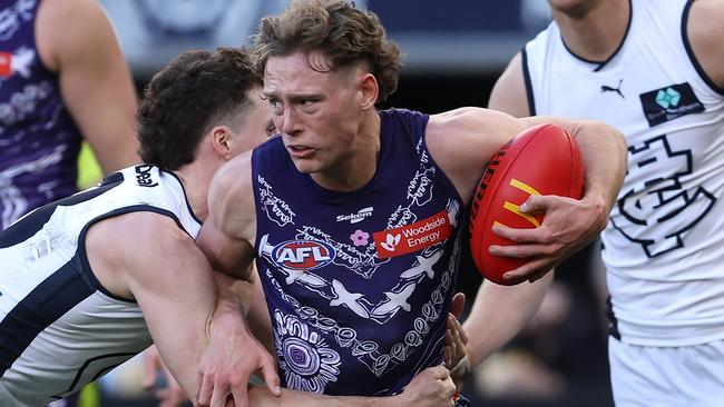 PERTH, AUSTRALIA - JULY 09: Matthew Johnson of the Dockers looks to break from a tackle by Blake Acres of the Blues during the round 17 AFL match between Fremantle Dockers and Carlton Blues at Optus Stadium, on July 09, 2023, in Perth, Australia. (Photo by Paul Kane/Getty Images)