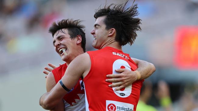 Logan McDonald, pictured right celebrating a goal with fellow young gun Errol Gulden, says he is ‘very happy’ at the Swans. Picture: Michael Klein