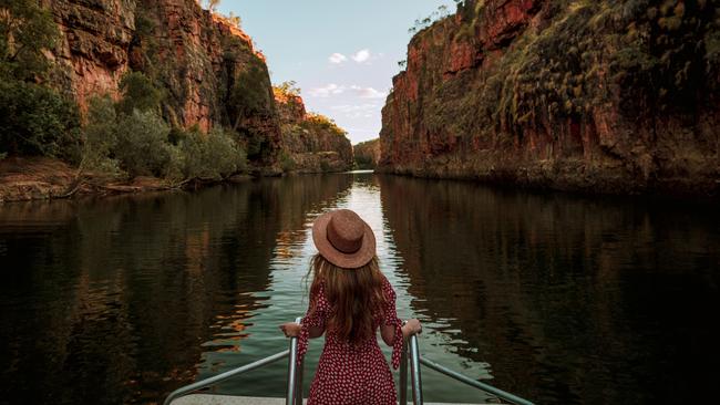 ESCAPE: A visitor stands at the front of a cruise boat as it travels along Katherine Gorge. Nitmiluk National Park covers a vast area of escarpment country, including 13 gorges along the Katherine River carved from the ancient sandstone country. Picture: Tourism NT/Emilie Ristevski