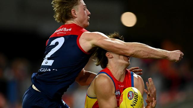 GOLD COAST, AUSTRALIA - MAY 06: Charlie Ballard of the Suns suffers an injury while challenging for the ball against Jacob van Rooyen of the Demons  during the round eight AFL match between the Gold Coast Suns and the Melbourne Demons at Heritage Bank Stadium, on May 06, 2023, in Gold Coast, Australia. (Photo by Albert Perez/AFL Photos via Getty Images)