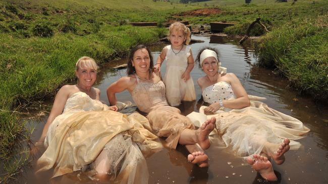 Kay Hollyoak, left, Sally and her daughter Cheeky Hopper and Beth Newton raised money for charity by trashing their wedding dresses. Picture: Brett Wortman