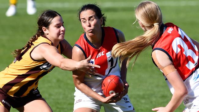 Darebin captain Stephanie Simpson gets a handball clear. Picture: Steve Tanner