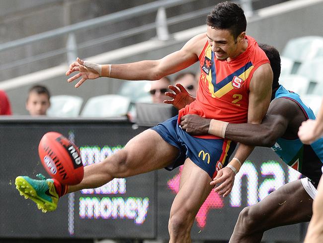 South Australia’s Izak Rankine gets his kick away against the Allies. Picture: ROGER WYMAN