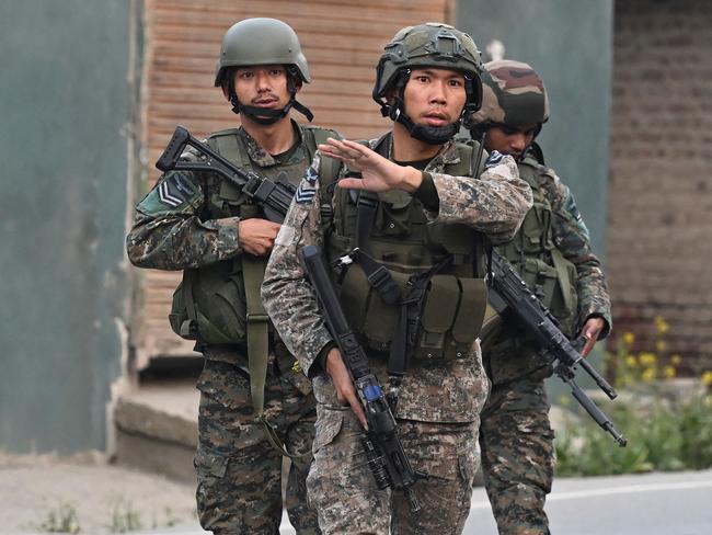 Indian soldiers walk along a street in Wuyan near Indian-administered Kashmir’s main city of Srinagar after a loud explosion was heard. Picture: AFP