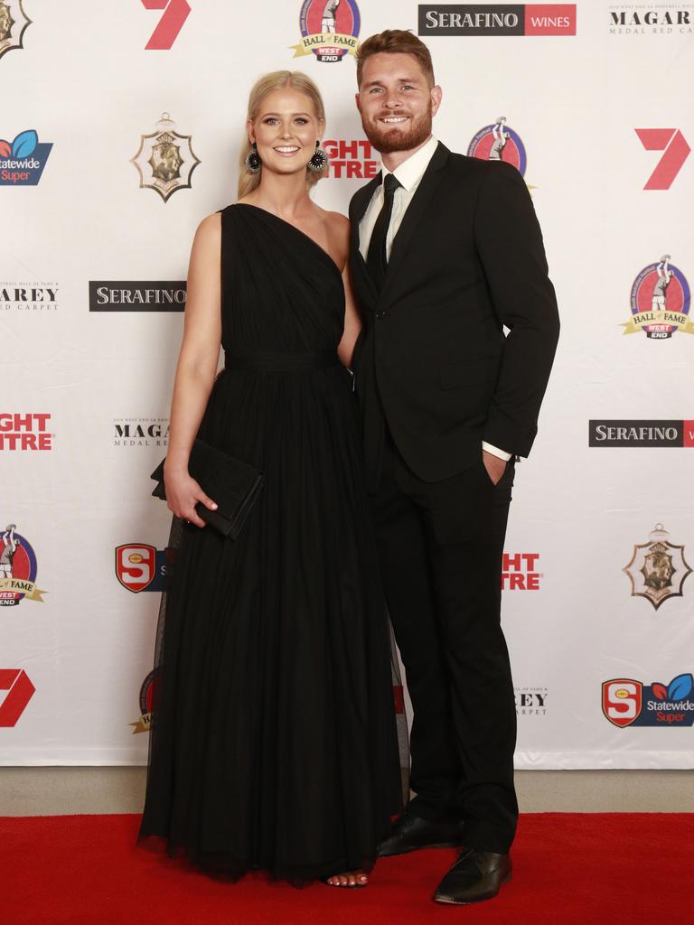 Jess Ogilvie wearing ASOS and Brad McKenzie pose for a picture on the red carpet at Adelaide Oval in North Adelaide, for the Magarey Medal, Monday, September 9, 2019. Picture: Matt Loxton