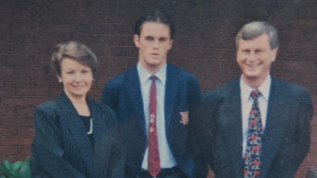 Minns as a young man with his parents Cara and John Minns.