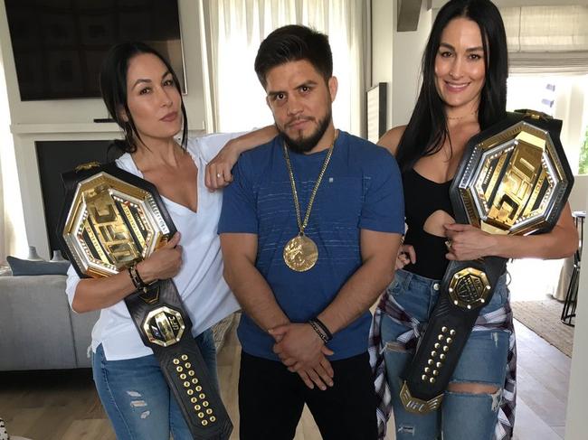 UFC star Henry Cejudo with the WWE's Bella Twins.