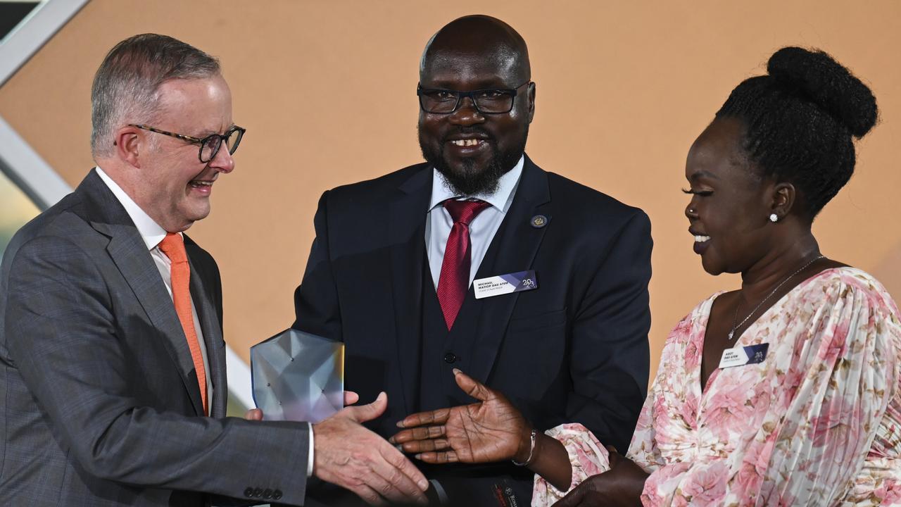 Australian Prime Minister Anthony Albanese presents the Young Australian of the Year winner to mother Agot Dau Atem and uncle Michael Matiop of Awer Mabil during the 2023 Australian of the Year Awards at the National Arboretum on January 25, 2023 in Canberra, Australia. (Photo by Martin Ollman/Getty Images)