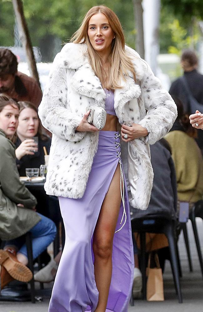 She wore a fluffy coat over the skimpy outfit as she entered the restaurant. Picture: Media Mode