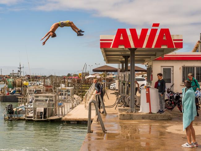 In a seaside resort town in France, a gas station is suddenly transformed into a spectacular diving board, from which some boys jump into the sea with daring and breathtaking acrobatics. Picture: Benoit Segalen