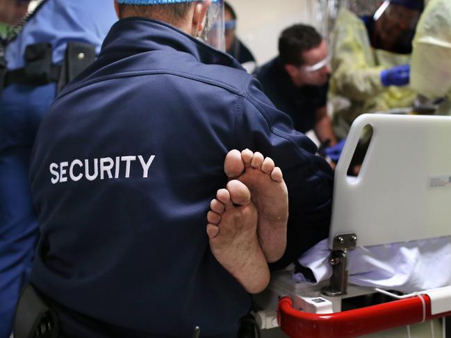 Police and security staff help doctors as they treat a man affected by ice psychosis in an incident at Royal Perth Hospital’s Emergency Department. Picture: Gary Ramage