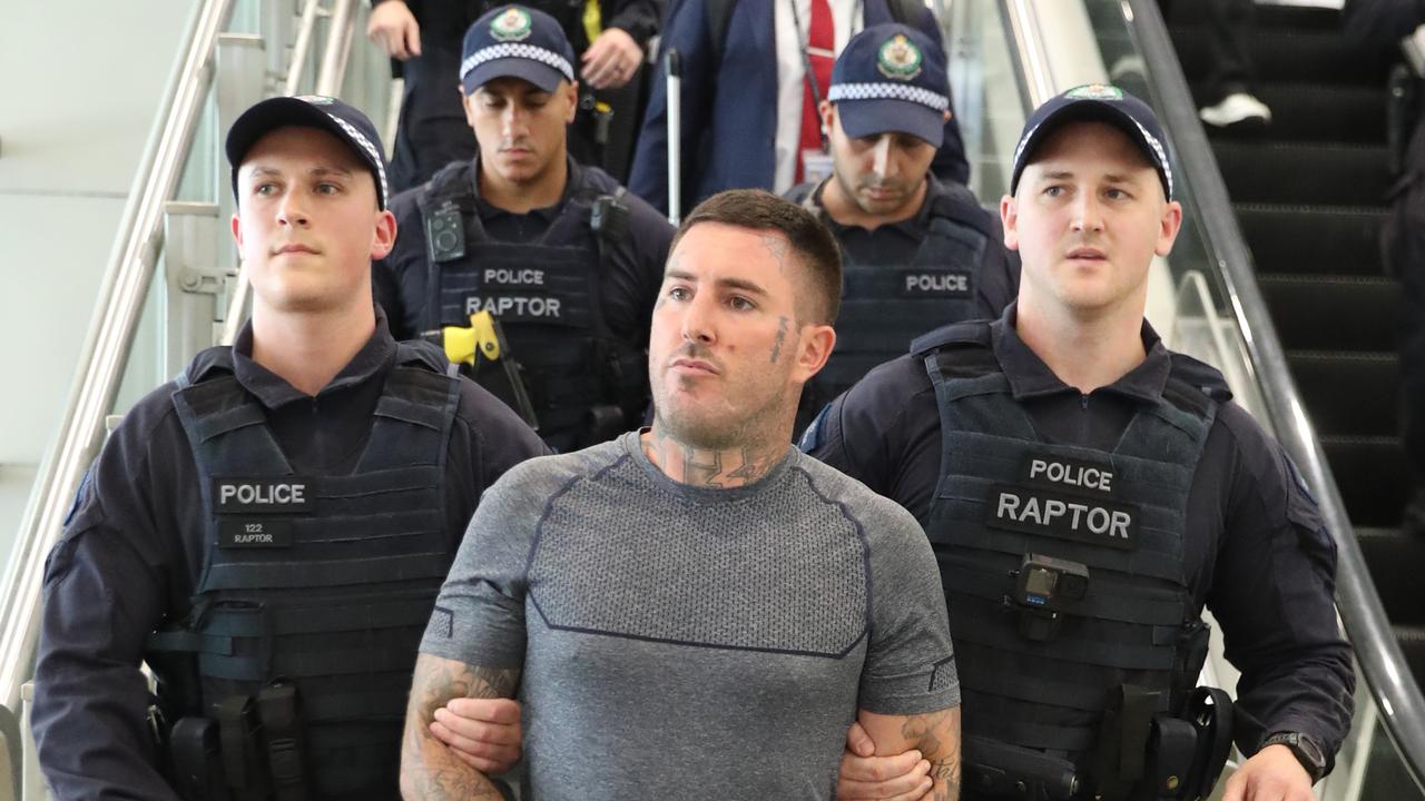 Meehan was escorted through Sydney airport by a throng of cops last month. Picture: John Grainger