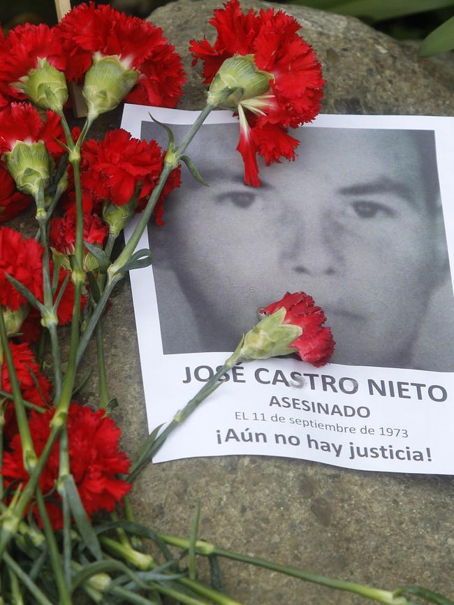 People put flowers on the tombs of people killed in the coup earlier this month during the 44th anniversary of Pinochet’s coup. Picture: AFP