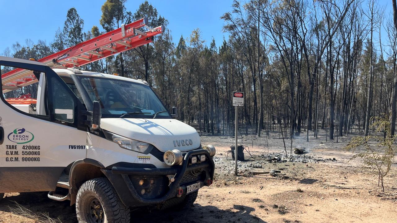 Ergon Energy workers trying to restore power following multiple power poles burnt to ashes in Tara. Picture: Ergon Energy