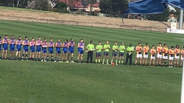 Trinity Old Scholars and Rosewater players clap for a minute before the division six grand final in honour of Maggie Varcoe. Picture: Daniela Abbracciavento