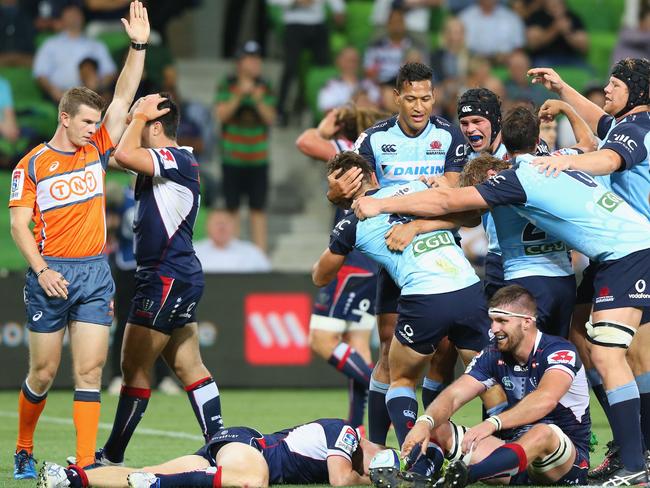 Waratahs teammates celebrate Bernard Foley’s match winning try.