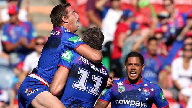 Kurt Gidley celebrates a try with teammates.