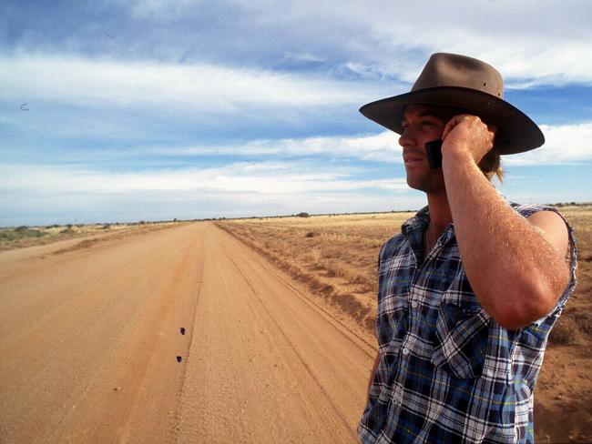 Man in outback using mobile telephone in scene from Telstra telecommunications "Making Life Easier" advertisement TV commercial Oct 1998. phone /Advertising /Telecommunications