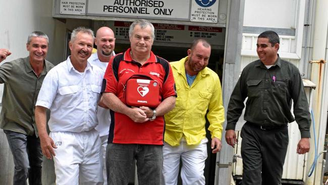 Dave Carroll in the centre holding the defibrillator, with the men who saved his life- Darren Grimston, Darrell Schultz, Jason Keep, Luke Murphy and Steve Formaggian outside the boning room at Casino's NCMC. Picture: Susanna Freymark