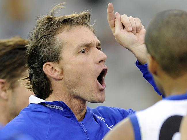 Laidley gives instructions to Roos players in a clash with Hawthorn at the MCG. Laidley says of coaching she was physically and mentally exhausted.