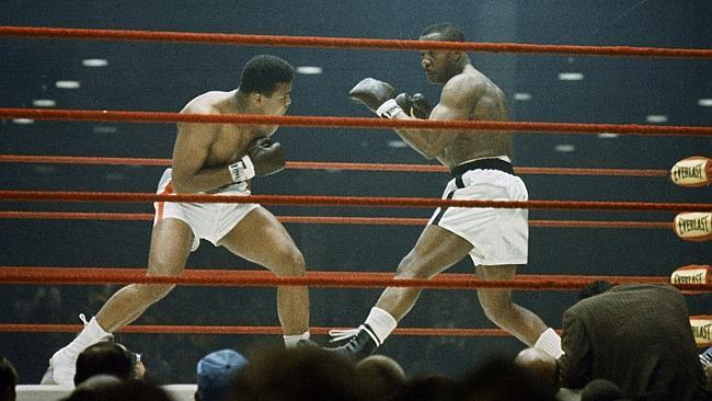 Cassius Clay, left, who later became Muhammad Ali, fights Sonny Liston during their heavy