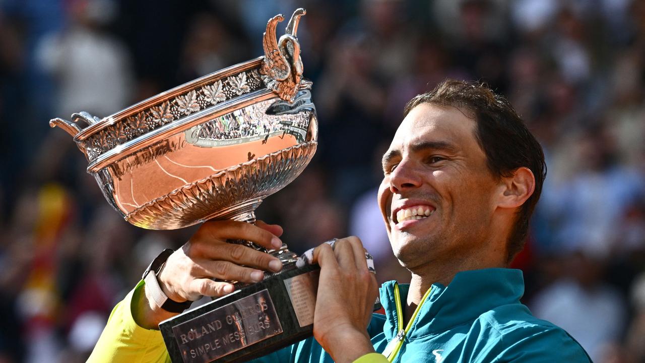 Spain's Rafael Nadal poses with The Musketeers' Cup as he celebrates after victory over Norway's Casper Ruud. (Photo by Anne-Christine POUJOULAT / AFP)