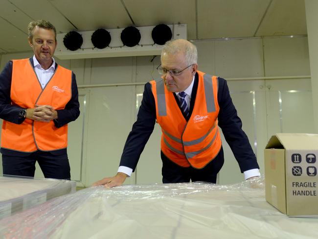 Prime Minister Scott Morrison with a pallet of domestically manufactured COVID-19 vaccines. Picture: NCA NewsWire/Andrew Henshaw