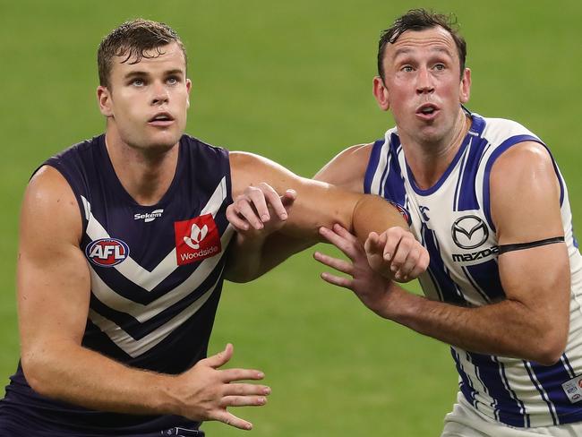 PERTH, AUSTRALIA - APRIL 24: Sean Darcy contests a ruck with Todd Goldstein during the 2021 AFL Round 06 match between the Fremantle Dockers and the North Melbourne Kangaroos at Optus Stadium on April 24, 2021 in Perth, Australia. (Photo by Will Russell/AFL Photos via Getty Images)