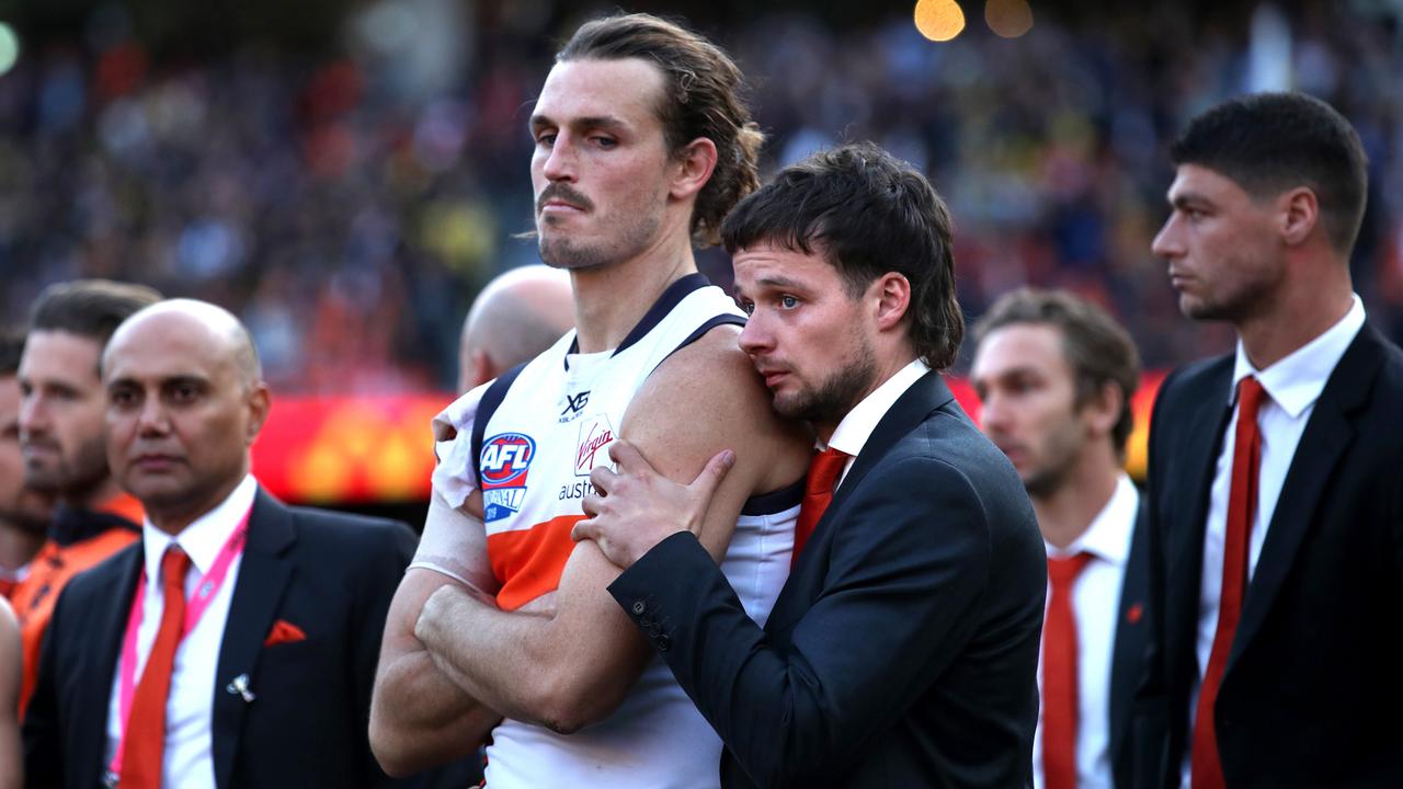 GWS Giants captain Phil Davis is consoled by Dylan Buckley after the Grand Final.