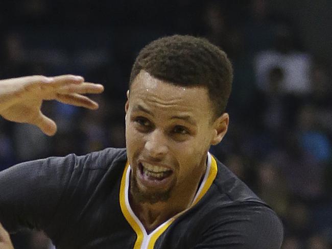 Golden State Warriors' Stephen Curry, right, drives against Milwaukee Bucks' Michael Carter-Williams, left, during the first half of an NBA basketball game Saturday, Dec. 12, 2015, in Milwaukee. (AP Photo/Aaron Gash)