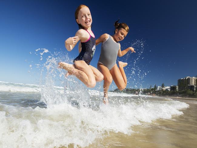 Best mates Indi Wayland 8, and Ivy Buswell 8, cool off at Coolum after school on a sweltering day across south east Queensland. Photo Lachie Millard