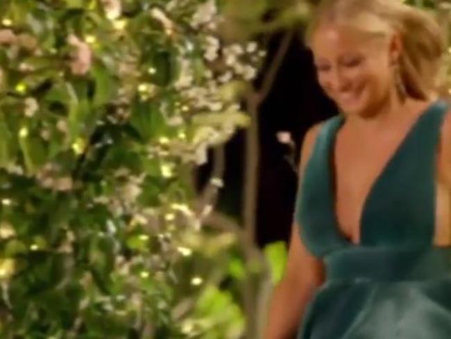 A glowing blonde in a long green dress smiles as she approaches Cummins. Picture: Channel 10