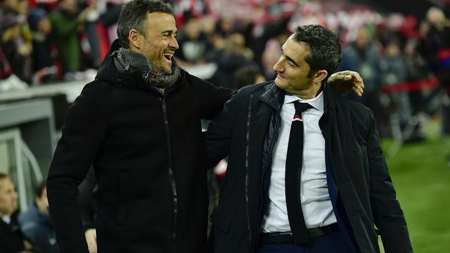 Barcelona's manager Luis Enrique, left smiles beside Athletic Bilbao's manager Ernesto Valverde