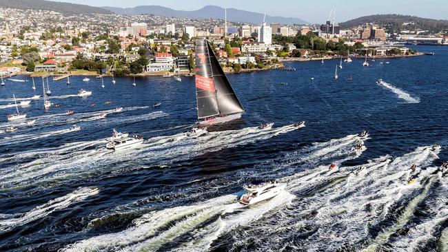 Wild Oats XI charges up the Derwent to claim line honours in the Sydney to Hobart race, but the crew’s celebrations may be shortlived after the race committee’s protest. Picture: AFP / Rolex