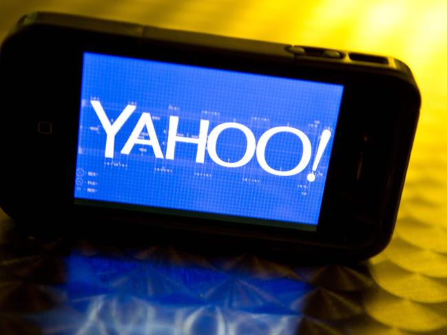 (FILES) This file photo taken on September 12, 2013 shows an illustration of the newly designed Yahoo logo seen on a smartphone. Yahoo on February 2, 2016 said it is cutting 15 percent of its workforce and narrowing its focus as it explores "strategic alternatives" for what to do with the faded Internet star. The announcements came as the California company reported a loss of $4.43 billion in the final three months of last year, due mostly to lowering the value of its US, Canada, Europe, Latin America and Tumblr units. / AFP / KAREN BLEIER