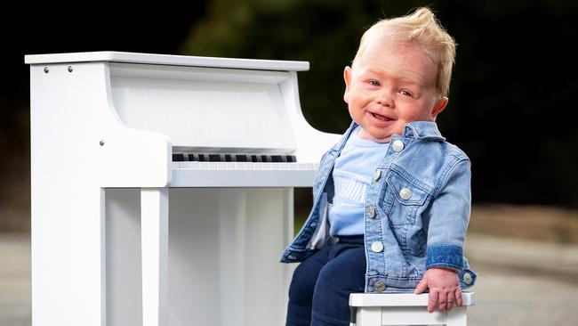 Smiling little Leo Cussen loves music and playing the piano. Picture: Mark Stewart