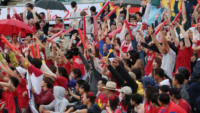 South Korean supporters cheer their team.