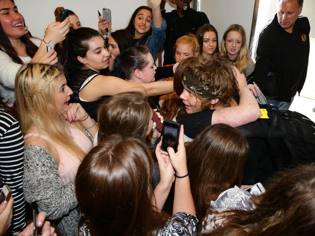 Fandemonium ... 5SOS were greeted by a mob of wellwishers when they arrived in Sydney this week. Picture: Cameron Richardson