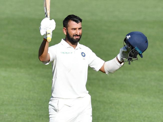 Cheteshwar Pujara raises his bat after notching his century on day one of the first Test. Picture: AAP