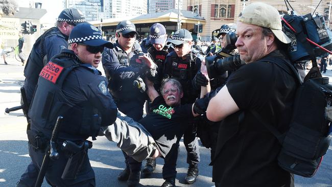 Another protester is taken away by police. Picture: Josie Hayden