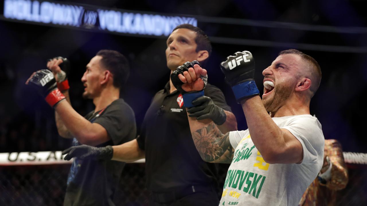 Alexander Volkanovski (R) celebrates winning the UFC strap from Holloway. Picture: Steve Marcus/Getty