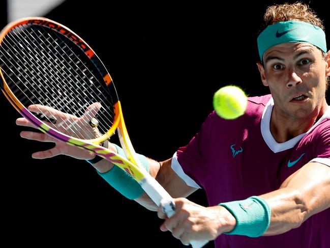 Spain's Rafael Nadal hits a return against Marcos Giron of the US during their men's singles match on day one of the Australian Open tennis tournament in Melbourne on January 17, 2022. (Photo by Brandon MALONE / AFP) / -- IMAGE RESTRICTED TO EDITORIAL USE - STRICTLY NO COMMERCIAL USE --