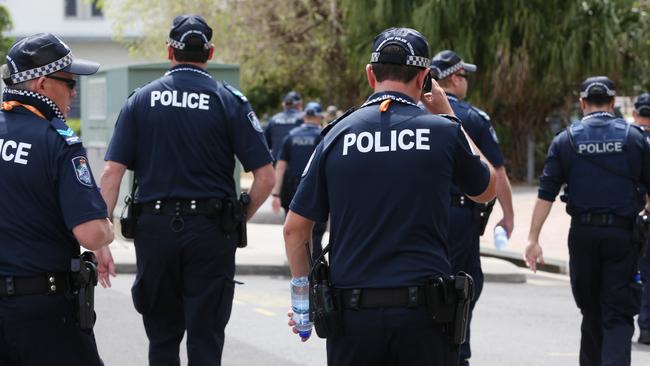 Protesters gather at the Reef Casino in Cairns and march to the Cairns Convention Centre, where the G20 Finance Ministers Meeting is being held. A large police presence occupied the Cairns CBD all weekend. Queensland Police officers patrol Hartley Street. Picture: Brendan Radke.