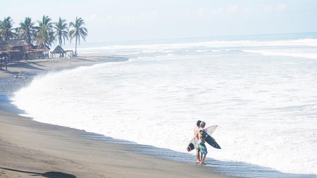 Louis Tikaram surfing with a friend on the Pacific Coast of Mexico.